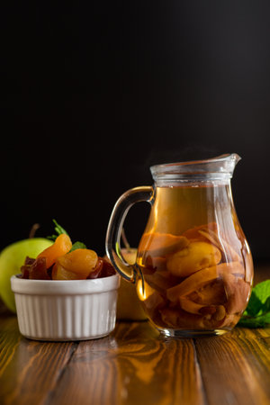 Homemade vitamin compote with mint, isolated on black background.の写真素材