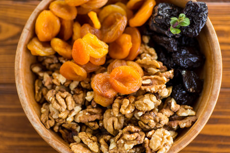 Natural dried Prunes, dried apricots and nuts close-up in macro photography.の写真素材