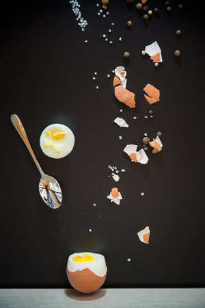 Black background, minimalism and egg in section.