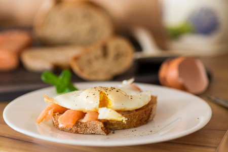 Diet breakfast with cooked egg and lightly salted red fish.