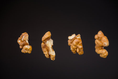 peeled walnuts isolated on black background.の写真素材