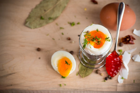 boiled egg for breakfast, on a wooden board.の写真素材