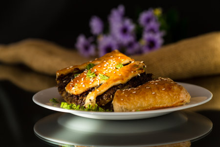 cooked simple puff pastries with mushroom filling isolated on black background.の写真素材