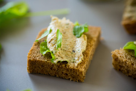 Homemade snack of rye bread with arugula and salad.