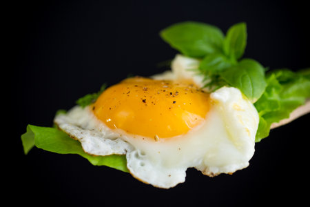 Appetizing fried egg with greens.の写真素材