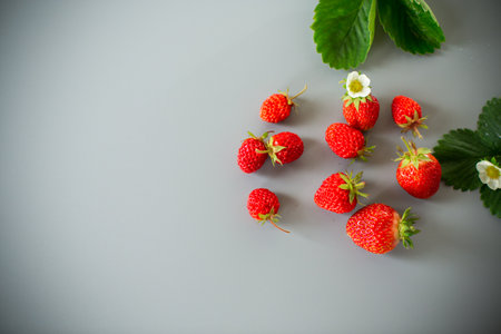 Fresh strawberries of juicy red color on a minimalistic background.の写真素材