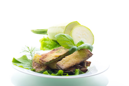 Zucchini with a crispy crust and fresh salad.の写真素材