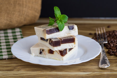delicate milky coffee jelly in a plate with a sprig of mint.の写真素材