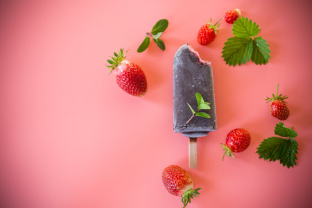 Bright strawberry ice cream with greenery on the background.の写真素材