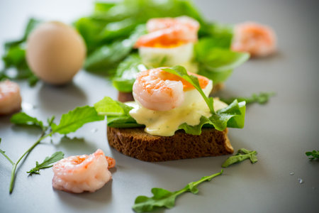 Delicious toast with salad, shrimp and boiled egg.