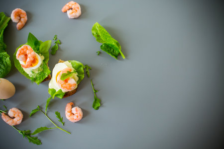 Appetizing breakfast with shrimp, egg and greens from above.の写真素材