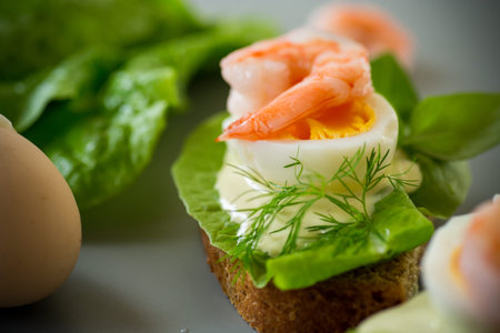 Delicious toast with salad, shrimp and boiled egg.の写真素材