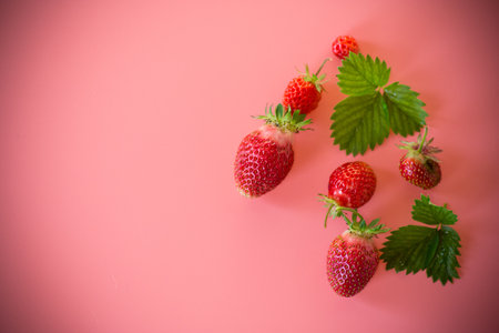 Bright juicy strawberries on a minimalist background.の写真素材