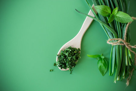 Top view of dried herbs and fresh green onions.の写真素材
