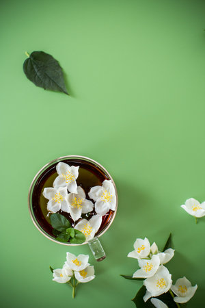 Green tea with jasmine in a glass teapot from above.の写真素材