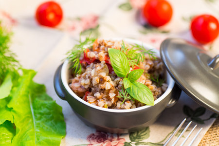 simple dinner with buckwheat and vegetables in a ceramic bowl.の写真素材