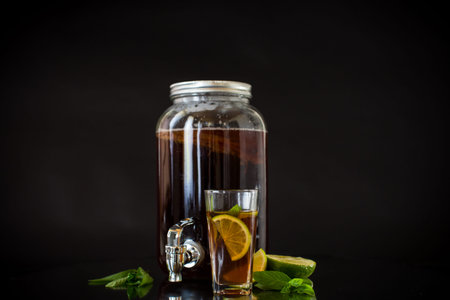Homemade kombucha starter with kombucha on a black background.