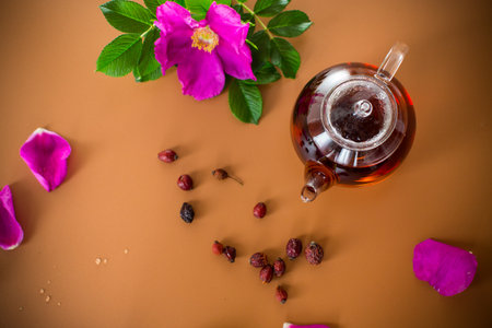 Herbal rosehip and mint tea in cup and teapot from above on brown background.の写真素材