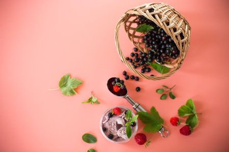 Blackcurrant ice cream with strawberries on pink.の写真素材