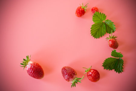 Bright juicy strawberries on a minimalist background.の写真素材