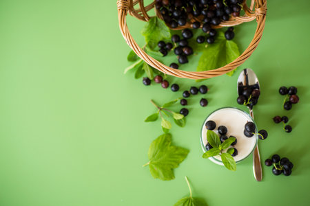 Natural berry yogurt, isolated on green surface.の写真素材