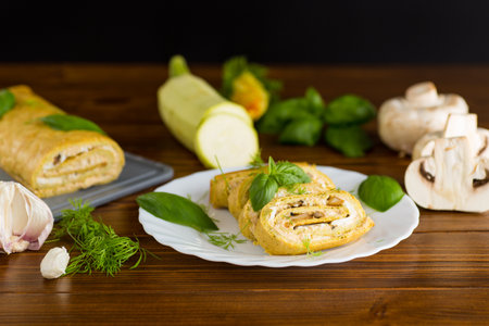 Zucchini roll with cheese and mushrooms on the table.の写真素材