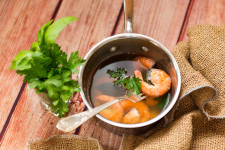 Close-up of boiled shrimps with lemon slices, on a wooden table.の写真素材