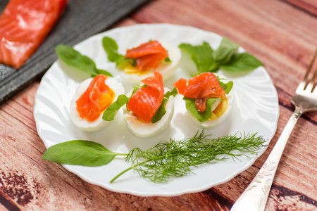 Cold festive appetizer of eggs with fish slices.