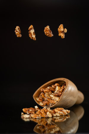 a handful of peeled walnuts in a wooden spatula.の写真素材