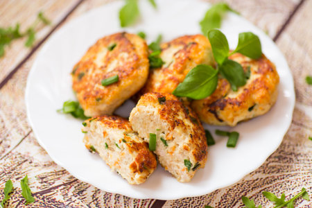 delicious chicken cutlets on a wooden table.