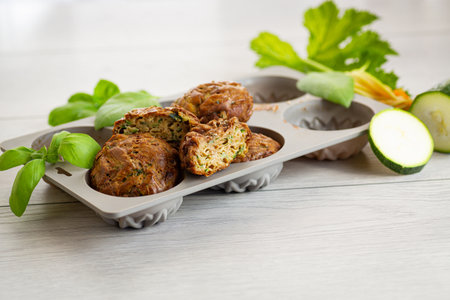 Homemade zucchini pastries on a light wooden table.の写真素材