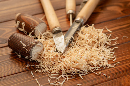 Carpentry tool set with wood shavings on wooden table.の写真素材