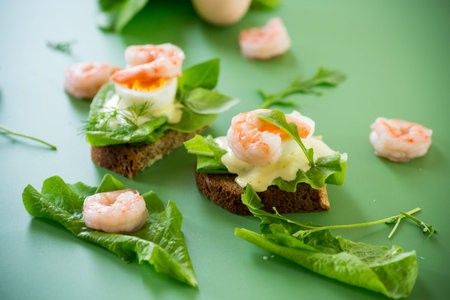 Delicious toast with salad, shrimp and boiled egg.