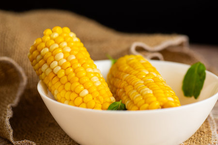 corn cobs with greenery on the table.