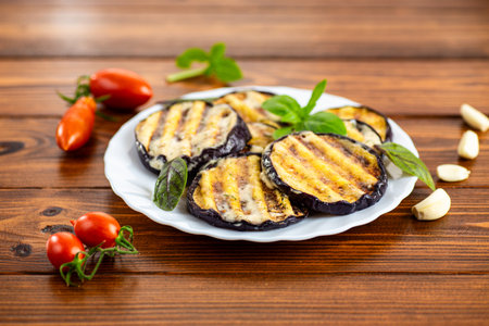 Appetizing eggplants with a golden crust and aromatic basil.の写真素材