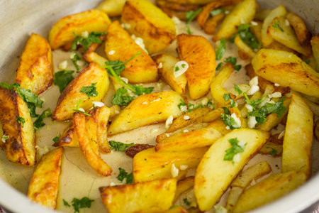 Golden potatoes with a crispy crust and spices.