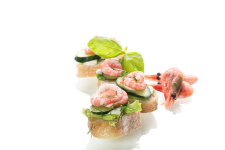 Appetizing appetizers with shrimps, sauce and cucumbers on a white background.の写真素材