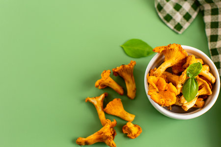 Close-up of fresh wild chanterelles on a table.の写真素材