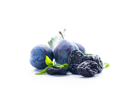 Tasty ripe plums with organic dried prunes background.の写真素材