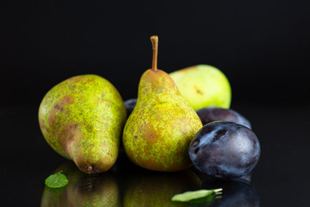 Natural fresh pears and plums in macro photography.の写真素材
