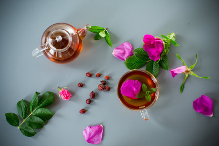Homemade rosehip and mint tea in a transparent cup and teapot.の写真素材