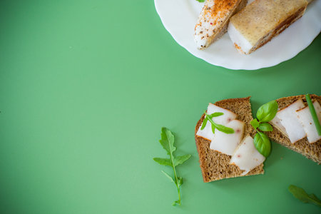 Black bread with lard and onions - top view, isolated.の写真素材