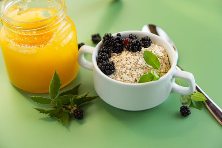 Healthy breakfast with oatmeal, berries and greens.