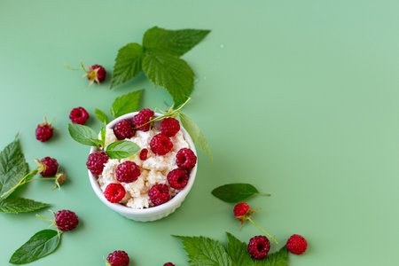 Healthy breakfast of cottage cheese with ripe raspberries.の写真素材