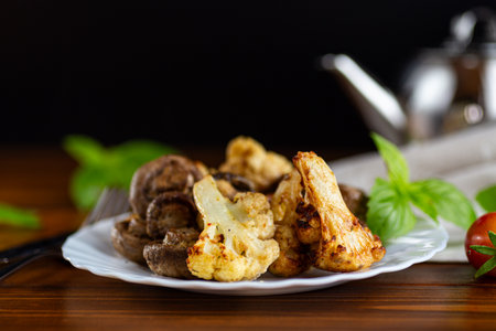 Healthy vegetarian meal with roasted cauliflower and mushrooms.の写真素材