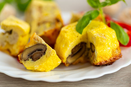 Delicious golden omelet with mushrooms and cauliflower pieces.の写真素材