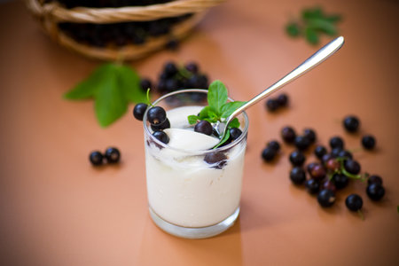 Homemade yogurt with blackcurrant on brown background.の写真素材