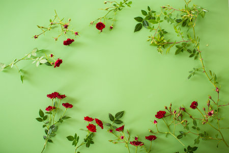 Floral arrangement with mini roses on green background.の写真素材