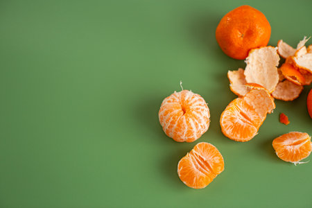Organic oranges and sweet peeled segments on minimal background.の写真素材