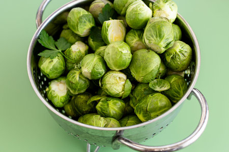 green Brussels sprouts in a colander.